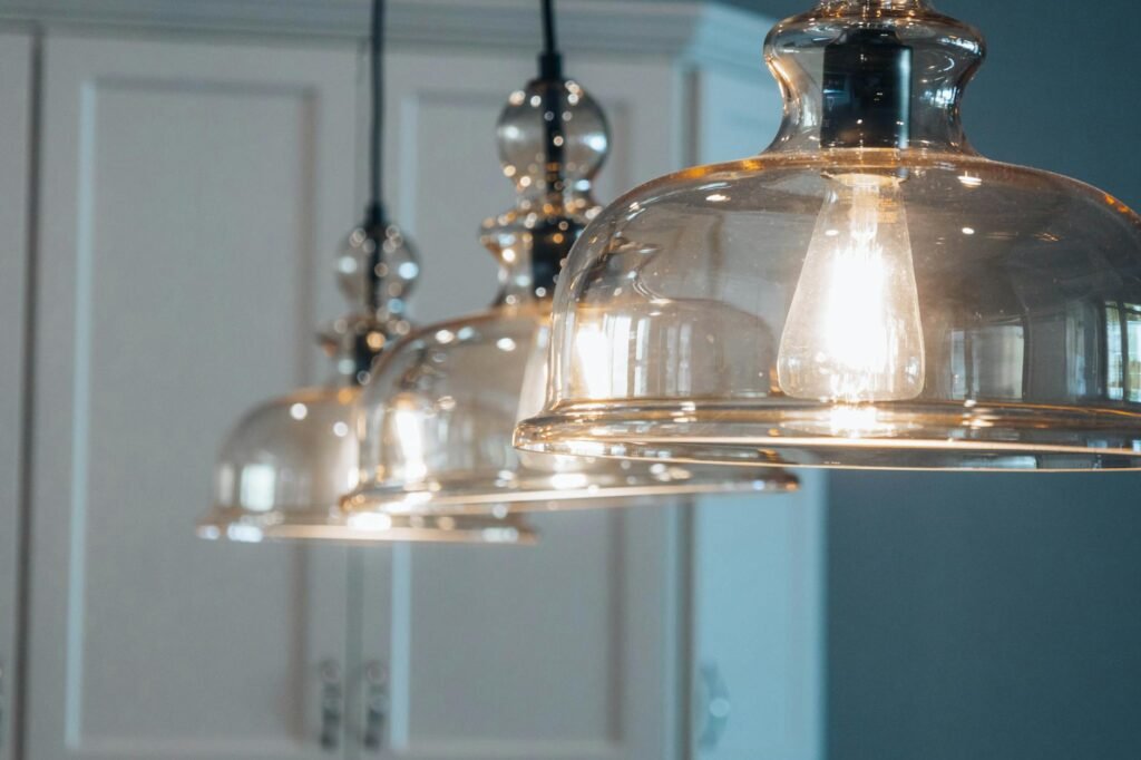 A dining room lit with warm pendant lighting in the evening