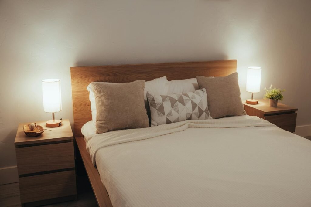 A primary bedroom with neutral bedding, matching lamps, and uncluttered surfaces.