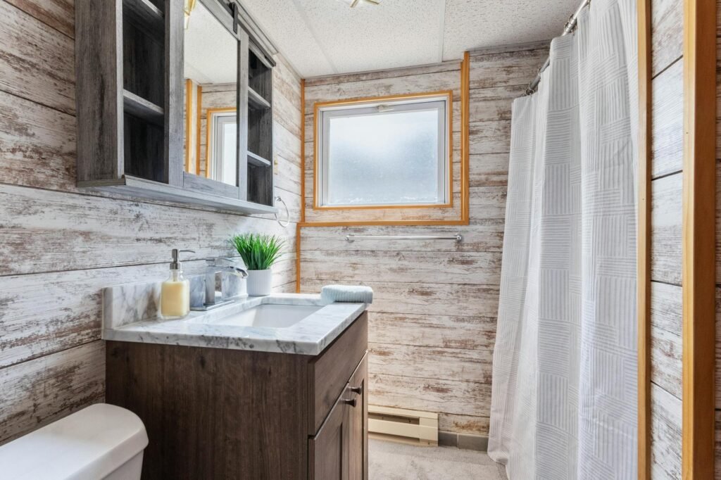 A bathroom vanity styled with white towels and minimal accessories