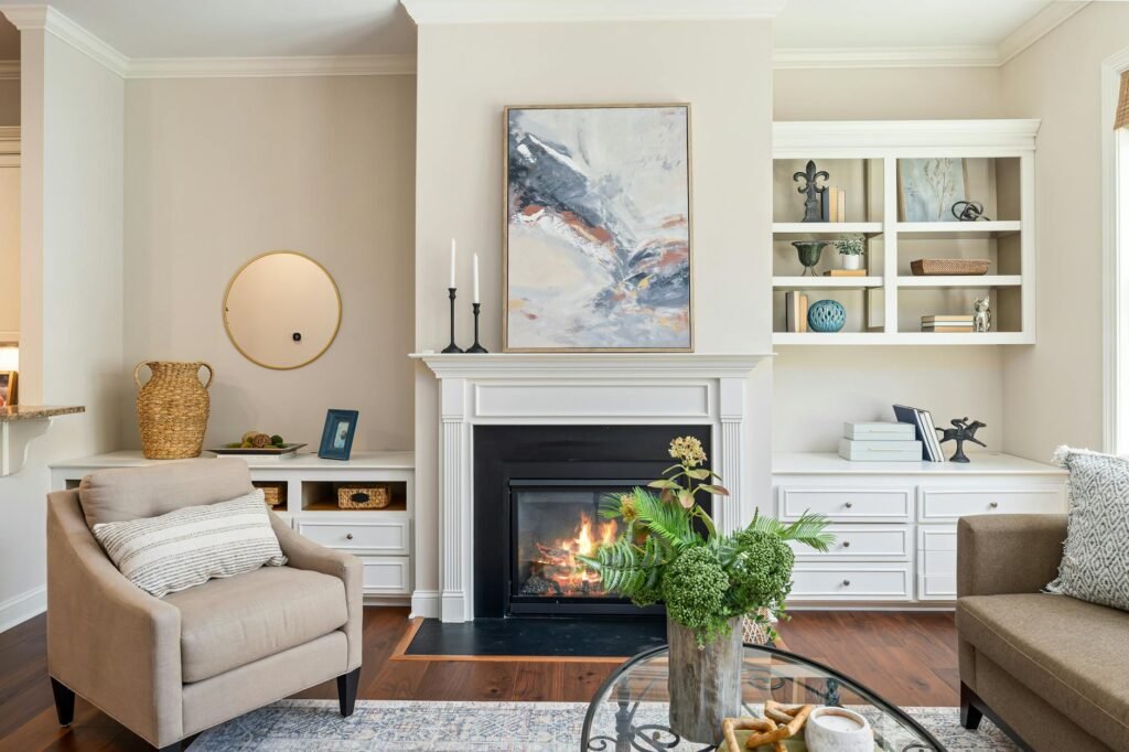A decluttered living room with a simple coffee table arrangement and an edited bookshelf.