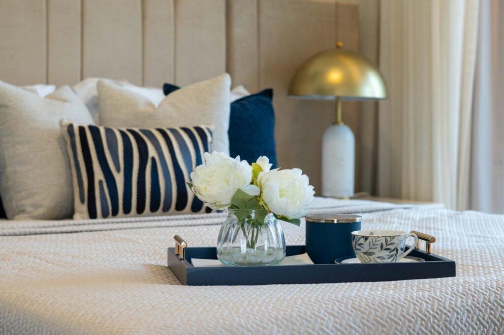 A basic dresser styled with better hardware, a lamp, and a tray