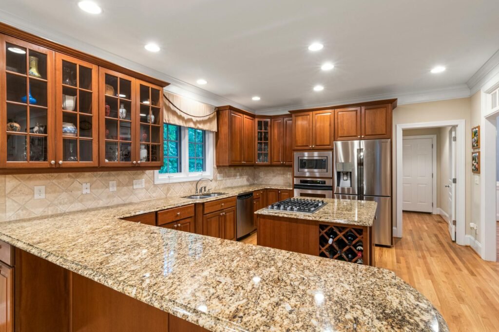 A kitchen with mostly clear counters, clean surfaces, and a few simple accessories.