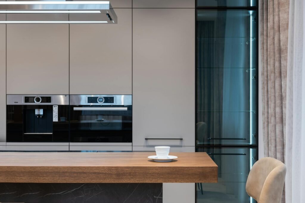 A clean kitchen counter with one coffee maker and minimal accessories