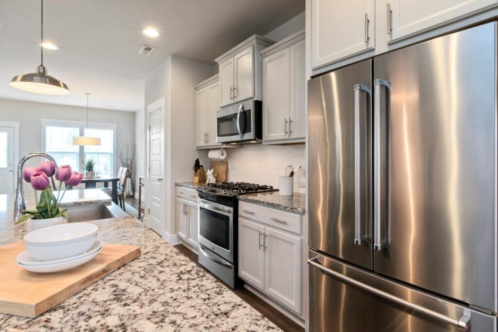 A clean kitchen with mostly clear counters and a simple staged setup.