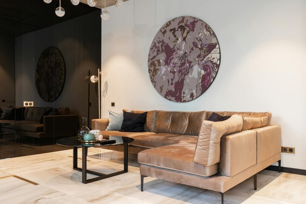 A small living room arranged with a slim sofa, round coffee table, and clear walkway.
