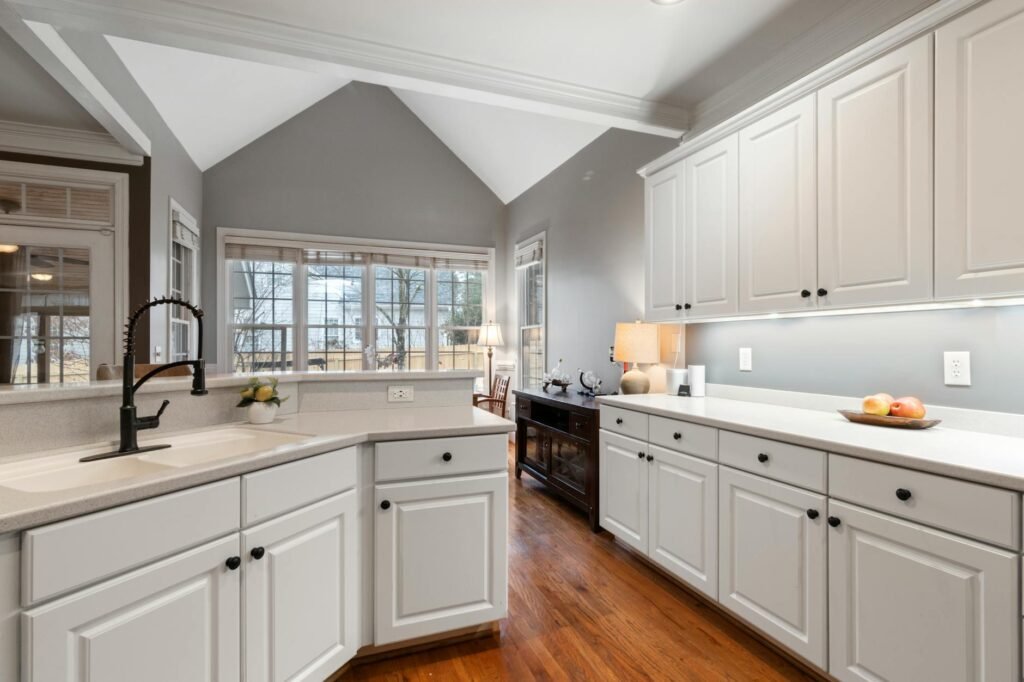 A bright kitchen with clean counters, cohesive hardware, and warm lighting.