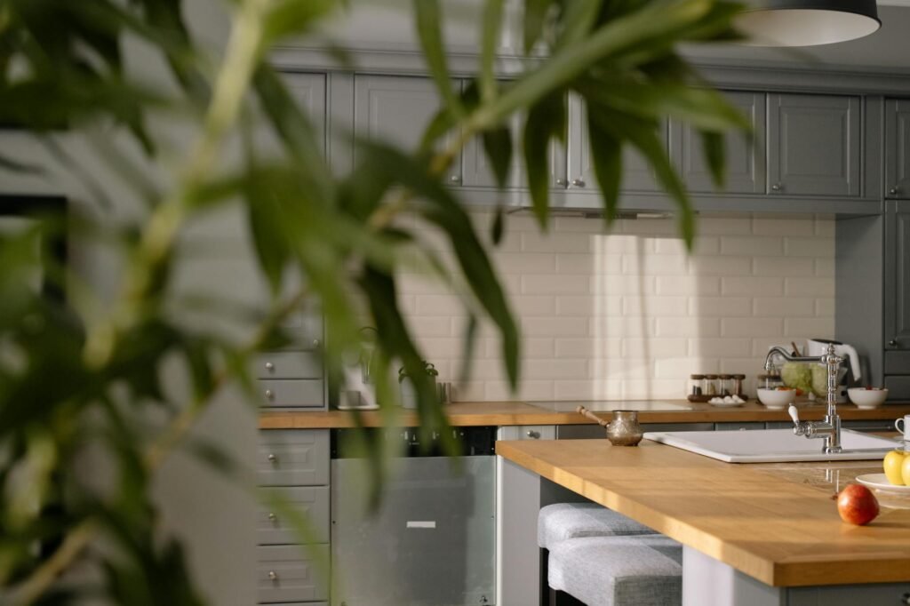 A staged kitchen with clear counters, bright light, and only a few simple accessories