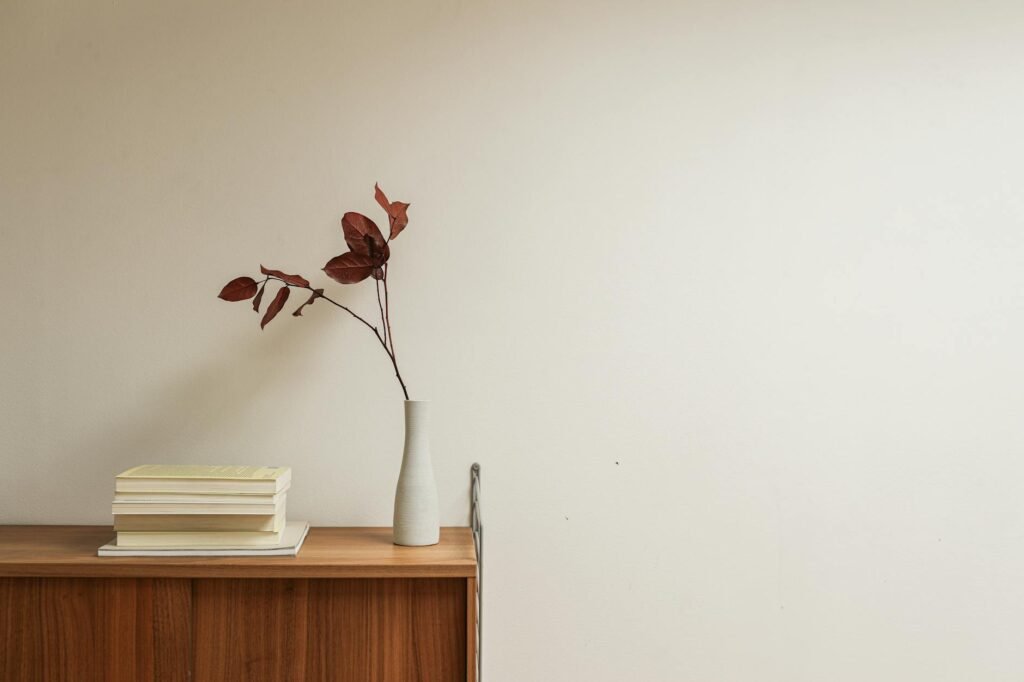 A shelf styled with a few objects and visible empty space between them