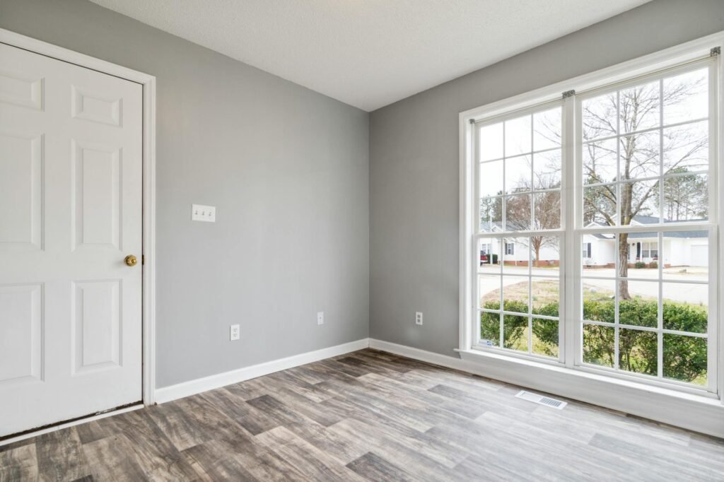 A freshly painted front door with clean hardware and a polished threshold.