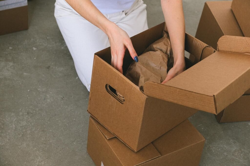 Storage bins and packing boxes neatly arranged in a bedroom closet during home sale prep.
