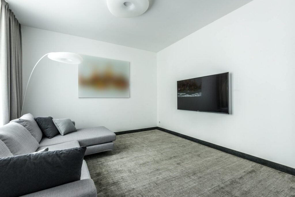 A staged living room with properly scaled furniture and one large piece of wall art.