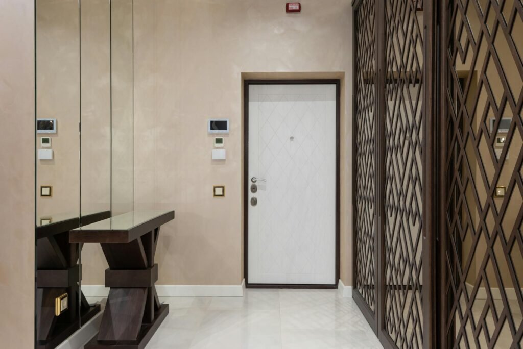 A small foyer with a slim console table, mirror, and runner arranged to keep the path open.